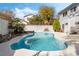 Sparkling in-ground pool with a tanning deck and mature landscaping, perfect for outdoor relaxation and entertaining at 6695 Shadow Cove Ave, Las Vegas, NV 89139