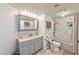 Traditional bathroom features a vanity, toilet and shower-tub combo with tiled walls at 6965 S Valley View Blvd, Las Vegas, NV 89118