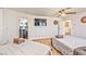Bright bedroom featuring two beds and a view into the en suite bathroom at 6965 S Valley View Blvd, Las Vegas, NV 89118
