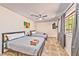 Comfortable bedroom with two beds, ceiling fan, and ample natural light at 6965 S Valley View Blvd, Las Vegas, NV 89118