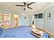 Bright bedroom with hardwood floors, ensuite bathroom, and a wall-mounted television at 6965 S Valley View Blvd, Las Vegas, NV 89118