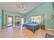 Bright bedroom featuring high ceilings, dual doors to the outside and hardwood floors at 6965 S Valley View Blvd, Las Vegas, NV 89118