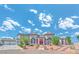 Elegant two-story home featuring symmetrical design, a red door, and a manicured landscape at 6965 S Valley View Blvd, Las Vegas, NV 89118