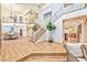 Expansive foyer with staircase, wood floors, and views to the dining room and living spaces at 6965 S Valley View Blvd, Las Vegas, NV 89118