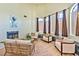 Bright living room boasts a fireplace, large windows, and stylish wicker and upholstered furniture at 6965 S Valley View Blvd, Las Vegas, NV 89118
