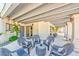 Inviting covered patio with comfortable seating arrangement perfect for relaxing and entertaining outdoors at 6965 S Valley View Blvd, Las Vegas, NV 89118