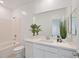 Bright bathroom with a tub-shower combo, white vanity with quartz countertop and decorative plants at 7304 N Decatur Blvd # 6, North Las Vegas, NV 89131
