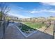 Exterior view of a fenced dog park area inside the community featuring green grass, benches, and dog waste station at 7304 N Decatur Blvd # 6, North Las Vegas, NV 89131