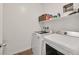 Efficient laundry room featuring modern washer and dryer units and convenient shelving for supplies at 7304 N Decatur Blvd # 6, North Las Vegas, NV 89131