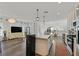 Open-concept living room and kitchen with modern lighting, hard surface flooring, and natural light at 7304 N Decatur Blvd # 6, North Las Vegas, NV 89131