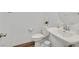 Clean powder room featuring a pedestal sink, white fixtures, and a decorative mirror at 7304 N Decatur Blvd # 6, North Las Vegas, NV 89131