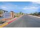 Street view showcasing the community entrance sign of the neighborhood and well-manicured landscaping at 7304 N Decatur Blvd # 6, North Las Vegas, NV 89131