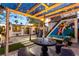 Backyard boasts vibrant murals, a pergola-covered dining area, and ample space for outdoor entertaining at 813 Bonita Ave, Las Vegas, NV 89104