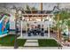 Charming backyard featuring a pergola-covered seating area, vibrant landscaping, and whimsical decor at 813 Bonita Ave, Las Vegas, NV 89104