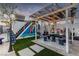 The backyard features a pergola, seating, and vibrant mural, creating an inviting outdoor space at 813 Bonita Ave, Las Vegas, NV 89104