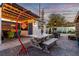 Backyard perfect for entertaining with a shaded dining area, outdoor lighting, and a 'Welcome to Las Vegas' sign at 813 Bonita Ave, Las Vegas, NV 89104