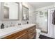Modern bathroom features a double sink vanity and a walk-in shower with marble-style tiling at 813 Bonita Ave, Las Vegas, NV 89104
