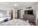 Stylish bedroom with a dresser, TV, and natural light streaming through the windows at 813 Bonita Ave, Las Vegas, NV 89104