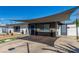 Modern home features a unique shade structure, xeriscaped yard, and inviting curb appeal at 813 Bonita Ave, Las Vegas, NV 89104