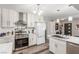 Modern kitchen boasting stainless steel appliances, white cabinetry, and a stylish range hood at 813 Bonita Ave, Las Vegas, NV 89104