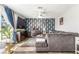 Cozy living room with a large sofa, patterned wallpaper, and ample natural light at 813 Bonita Ave, Las Vegas, NV 89104