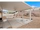 Spacious backyard with covered patio areas, mature landscaping and rock features with desert plants at 845 Holly Lake Way, Henderson, NV 89002