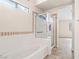 Bright bathroom with a soaking tub and a glass-enclosed shower and tile accents at 845 Holly Lake Way, Henderson, NV 89002