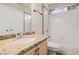 Bathroom featuring granite counters, framed mirror and a tiled shower-over-tub combination at 845 Holly Lake Way, Henderson, NV 89002