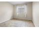 Cozy bedroom with tile flooring, bright natural light, and a window with white sheer curtains at 845 Holly Lake Way, Henderson, NV 89002