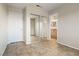 Bedroom with mirrored closet doors and an ensuite bathroom, all with neutral tile flooring at 845 Holly Lake Way, Henderson, NV 89002