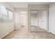 Bedroom featuring tiled floors, bright natural light, closet with sliding doors, and en suite bathroom at 845 Holly Lake Way, Henderson, NV 89002
