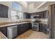 Modern kitchen with stainless steel appliances, granite countertops, and dark wood cabinets at 845 Holly Lake Way, Henderson, NV 89002