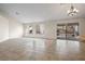 Bright living area with tile flooring, natural light, and a sliding glass door leading to the backyard at 845 Holly Lake Way, Henderson, NV 89002