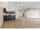 Spacious open concept living room next to the kitchen featuring tile flooring and neutral paint at 845 Holly Lake Way, Henderson, NV 89002