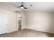 Neutral primary bedroom offering tiled flooring, a ceiling fan, and an en-suite bathroom at 845 Holly Lake Way, Henderson, NV 89002