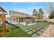 Wide shot of an open backyard that contains artificial grass, concrete pavers and a gazebo at 9024 Valla De Bravo, Las Vegas, NV 89131