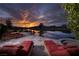 Resort-style backyard with lounge chairs overlooking tranquil lake and breathtaking sunset views, ideal for relaxing at , Henderson, NV 89011