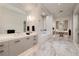 Bright bathroom with dual vanities, soaking tub, and marble flooring at , Henderson, NV 89011