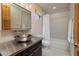 Modern bathroom featuring a sleek vanity with a vessel sink, a shower-tub combo, and neutral decor at , Henderson, NV 89011
