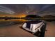 Covered boat on private dock at sunset, offering a serene waterfront lifestyle at , Henderson, NV 89011