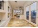 Hallway with hardwood floors leading to a staircase and a doorway to an outdoor balcony at , Henderson, NV 89011