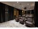 Luxurious home theater featuring comfortable leather seating, a projector, and elegant dark wood accents at , Henderson, NV 89011