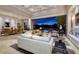 Expansive living room with floor-to-ceiling windows, fireplace, and seamless indoor-outdoor transition to lakeside patio at , Henderson, NV 89011