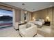 Comfortable main bedroom with balcony, seating area, and waterfront view at , Henderson, NV 89011