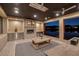 Cozy outdoor patio with a fireplace, wet bar, and stunning lake views at dusk at , Henderson, NV 89011