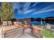 An outdoor patio featuring ample seating, built-in planters, and scenic lake views at night at , Henderson, NV 89011