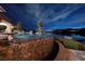 Stunning swimming pool at twilight with a breathtaking view of the lake and city lights in the distance at , Henderson, NV 89011