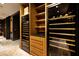 Custom wine cellar with glass-enclosed storage, wooden shelves, and elegant lighting, perfect for wine enthusiasts at , Henderson, NV 89011