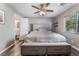 Bedroom with a large bed, ceiling fan and natural light from the window with blinds at 1030 Wild Fern Ct, Las Vegas, NV 89183