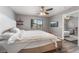 Bedroom with a gray bed, ceiling fan and an adjacent living room area at 1030 Wild Fern Ct, Las Vegas, NV 89183